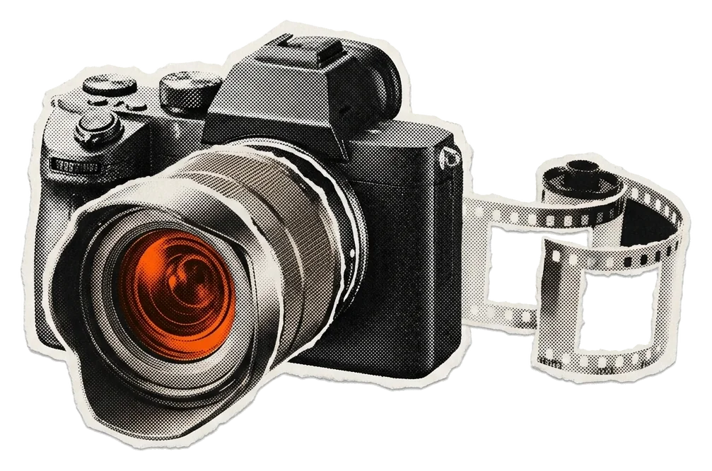 A camera with a glowing orange lens, a strip of film curling out beside it.